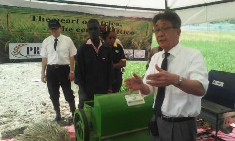 Dr. kazuhiko explainig how a rice thresher works