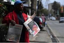 A newspaper vendor selling The Standard and Daily Nation, the most dominant privately owned newspapers in Kenya. Photo:Simon Main)